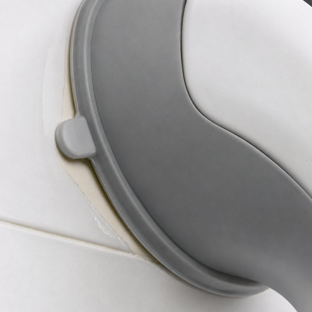 A suction cup with a pale crescent creeping under one side of the rim