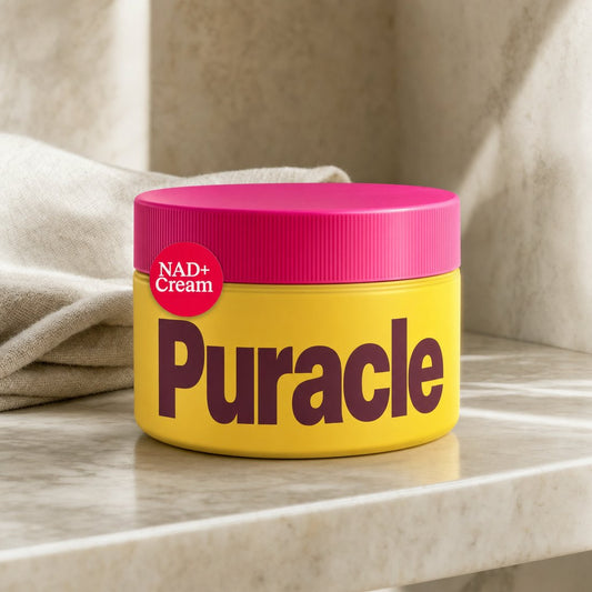 Puracle NAD+ Renewal Cream jar on a marble shelf in morning light