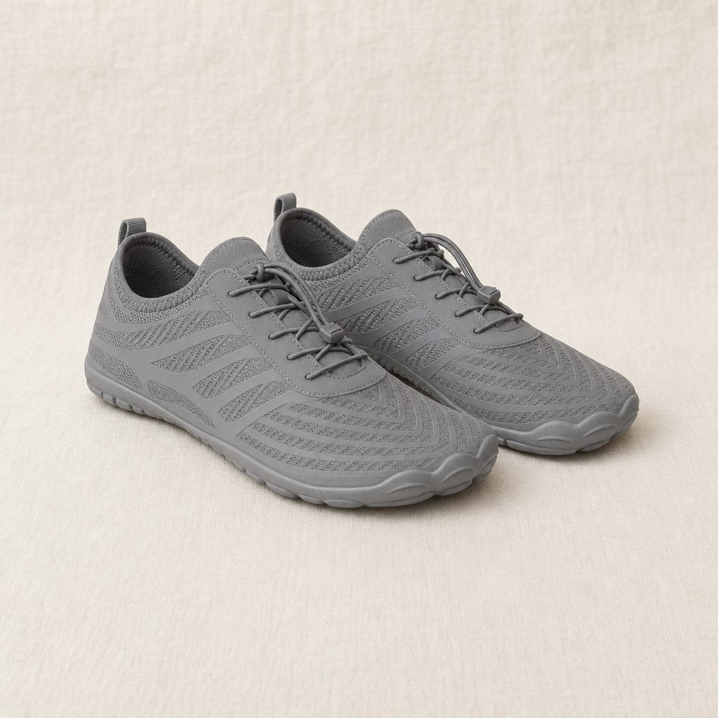 Grey barefoot shoes, pair, three-quarter view