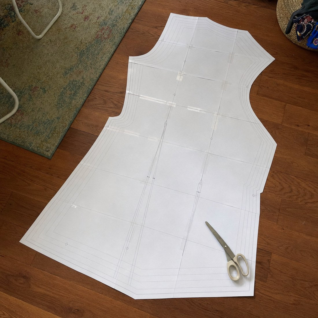A pattern printed at home and taped together on a wooden floor